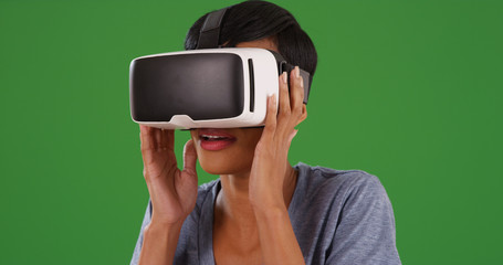 Black female using virtual reality headset on green screen