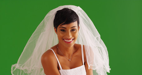Portrait of beautiful African American bride smiling at camera on green screen