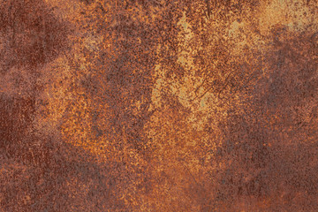 Rusty yellow-red textured metal surface. The texture of the metal sheet is prone to oxidation and corrosion. Textured Background in Grunge Style