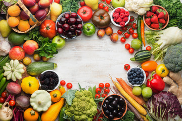 Healthy living, summer fruits vegetables berries arranged in a circle frame. Organic produce, raw eating, copy space, top view, selective focus