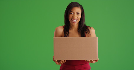 Happy African American woman with box mail package on green screen