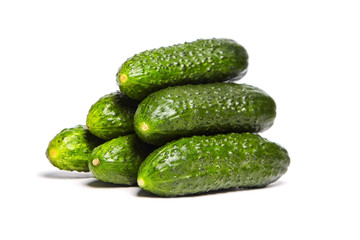 Heap of fresh green Cucumbers isolated on white background