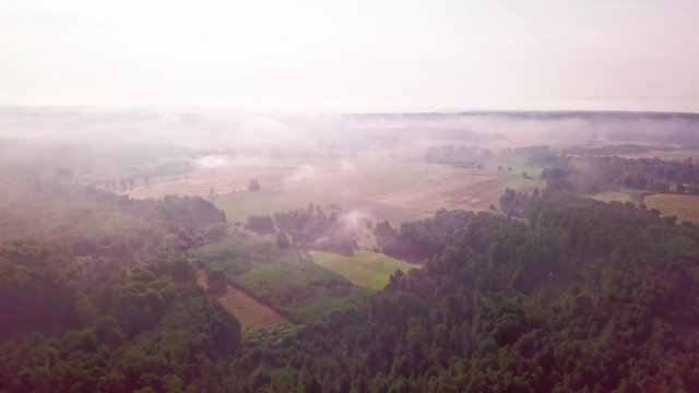 4j AERIAL: Flight over misty fields and forest at early autumn sunrise. Polish landscape. 3840x2160, 24fps.