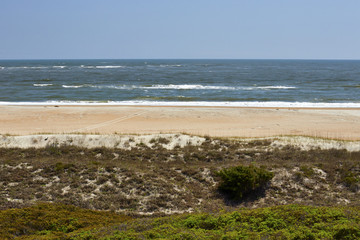 View of the Atlantic Ocean and beach, as viewed from a hiking trail at Fort Macon State Park, located on the Crystal Coast of North Carolina, USA