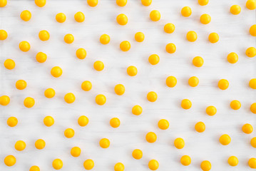 Wild yellow plums on white wooden background