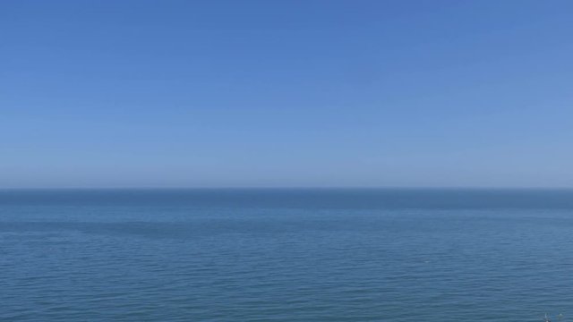 A sea horizon and blue sky. Britain.