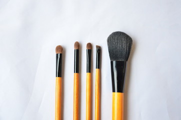 Cosmetic set of brushes and eye shadow on white background