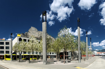 Newly-renovated bus- and train station forecourt showing peak of Gonzen, Sargans, Swiss Alps © elliottcb