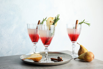Tasty refreshing pear cocktail with rosemary on table