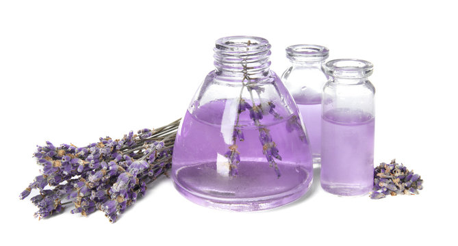 Bottles with aromatic lavender oil on white background