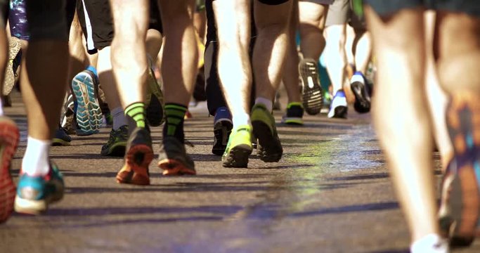 4K - Marathon athletes legs. back view