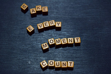 Make every moment count message written on wooden blocks. Motivation concepts. Cross processed image