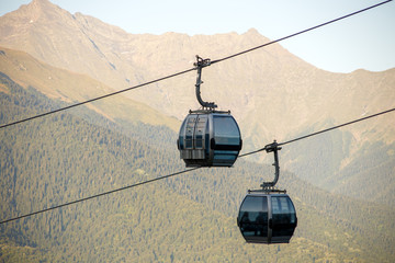 Fototapeta na wymiar Close-up photo of two funiculars among mountain hills