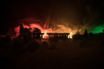 Train moving in fog. Ancient steam locomotive in night. Night train moving on railroad. toned foggy fire background. Horror mystical scene.