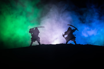 Silhouette of two samurais in duel. Picture with two samurais and sunset sky