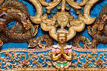 Fototapeta na wymiar Thai style cement carving art on temple wall in Wat Chai Mongkon - Buddhist Temple , Chiang Mai Thailand
