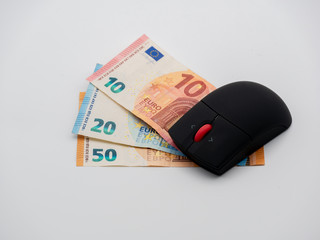 Top down view on Computer mouse on money bills