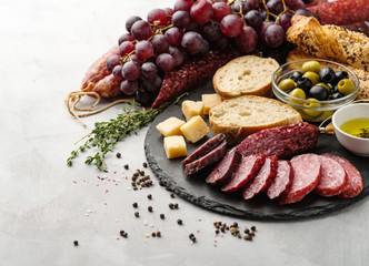 Salami sliced in rustic style. Salami sausage. Different sausages with cheese, grapes and olive