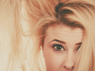 Naklejka premium Blonde woman holding her dry hair
