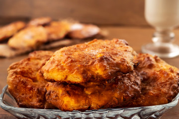 Cookies with cottage cheese filling in a glass plate, wooden background.