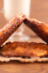Cookies stacked in a triangle shape, wooden background, vertical frame.