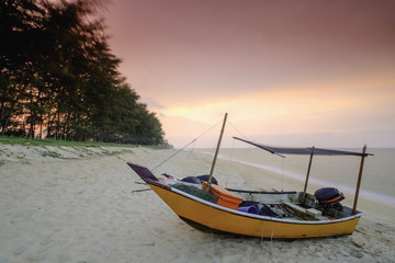 Naklejka na ściany i meble Fishing boats is parked on the beach during beautiful sunset at Kampung Mangkuk, Terengganu, Malaysia