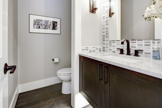 Bathroom modern interior with dark hardwood cabinets and large mirror