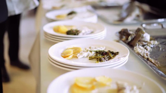 Catering food - catering company preparing large numbers of delicious gourmet meal for guests of a restaurant or hotel on event party. 4K (UHD).