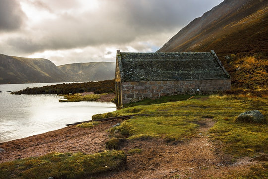 Scotland landscape. A boathouse at the edge of Loch Muick. Royal Deeside. Cairngorms National Park, Aberdeenshire, Scotland, UK.
