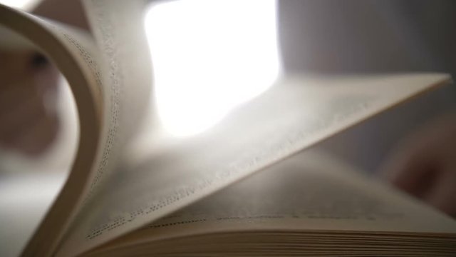 woman flipping through a book, close-up pages