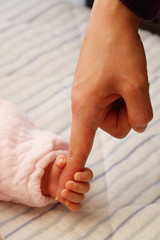 赤ちゃんと母親の手