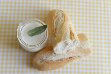 three jars with Greek yoghurt and a crispy French baguette