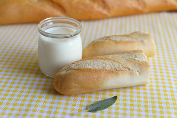 three jars with Greek yoghurt and a crispy French baguette