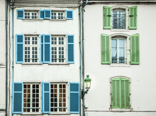 Colorful pattern of window panes and shutters on old building in Europe