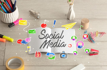 Notebook on the floor with instruments on the floor and social media, internet label on it