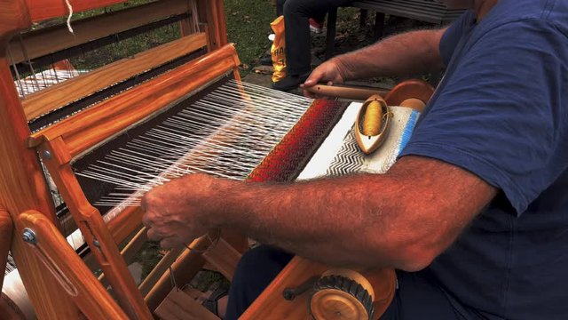 Weaver hands closeup working on the old loom, etara, bulgaria