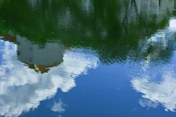 The shadows of religious buildings reflect on the surface of the waves, because of the small waves.