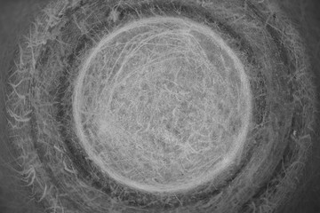 Detailed texture of circular scratched metallic surface close up. Brushed gray aluminum round background with copy space.