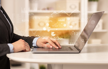 Business woman in homey environment using laptop with financial report concept
