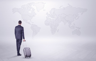 Businessman in dark suit planning his trip in a front of a map
