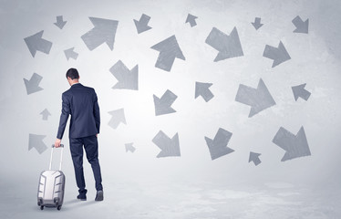Obraz premium Businessman with back walking away with higgledy-piggledy arrows around 