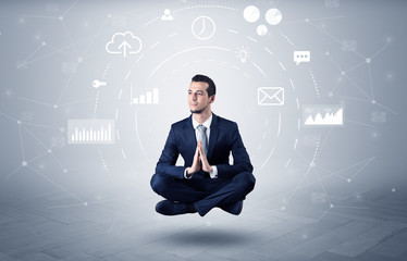 Elegant calm businessman levitates in yoga position with data circulation concept

