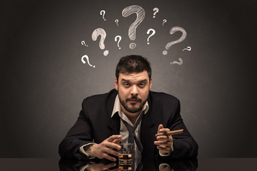 Young drunk disappointed man with question signs concept

