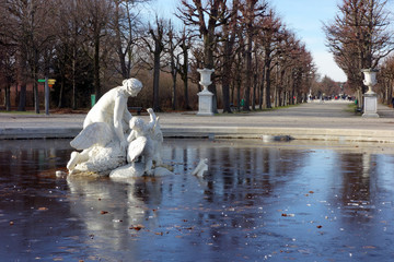 Frozen fountain with an sculpture in sch?nbrunn park in Vienna