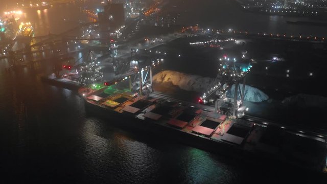 Cargo Ship Bulk Carrier Offloading Goods Aerial Time Lapse At Night 