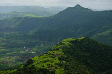 Beautiful landscape aerial, and closeup Photos of nature, roads, grass, trees, village, and farm land. Lush green monsoon nature mountains, hills, Purandar fort, Pune, Maharashtra, India