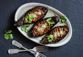 Stuffed lentils roasted eggplant - delicious healthy vegetarian lunch, snack, appetizer on a dark...