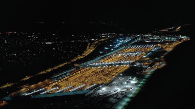 Timelapse of Vehicles Arriving and Departing a Motorail Terminal at Night