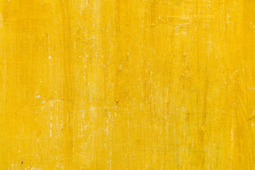 Background closeup textured bright yellow wall 