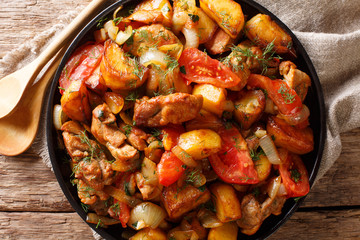Georgian traditional recipe ojahuri with pork and potatoes close-up. Horizontal top view